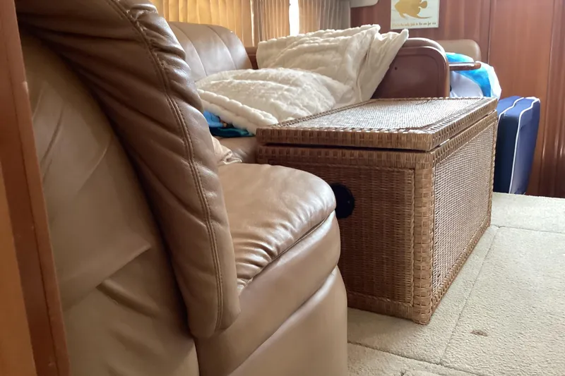 Slide: The Image of Interior of 2005 Carver 41 Cockpit Motor Yacht with leather seating and wicker storage. - 14