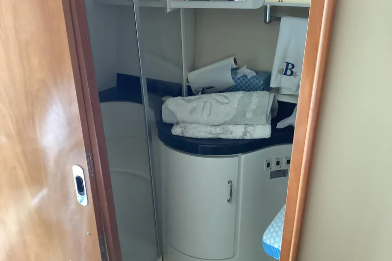 Slide: The Image of 2005 Carver 41 Cockpit Motor Yacht bathroom with towels and storage cabinet. - 19