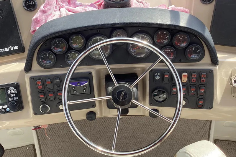 Slide: The Image of Steering wheel and dashboard of 2005 Carver 41 Cockpit Motor Yacht with gauges and controls. - 25