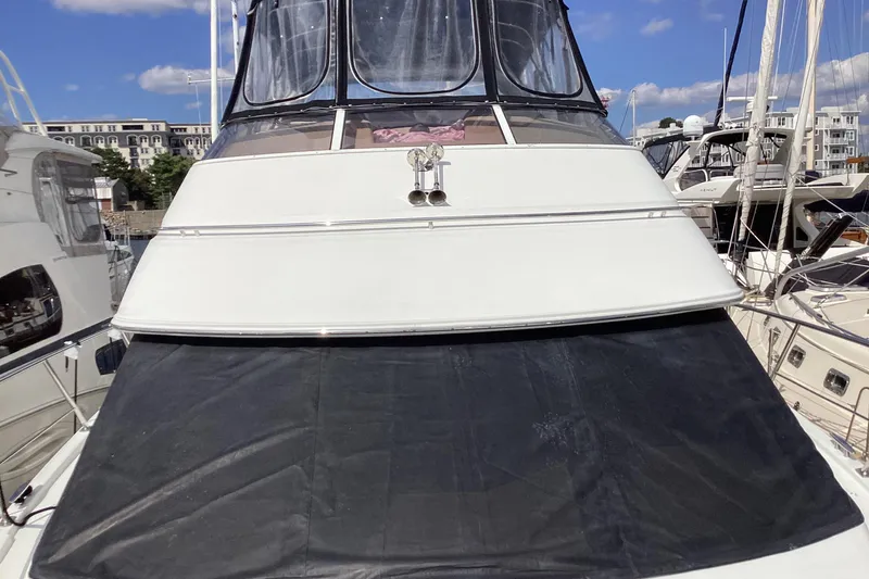 Slide: The Image of 2005 Carver 41 Cockpit Motor Yacht docked at marina under clear blue sky. - 28