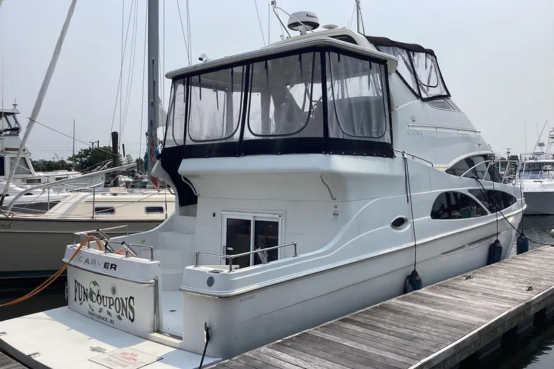 Slide: The Image of 2005 Carver 41 Cockpit Motor Yacht docked at marina, featuring enclosed upper deck. - 3