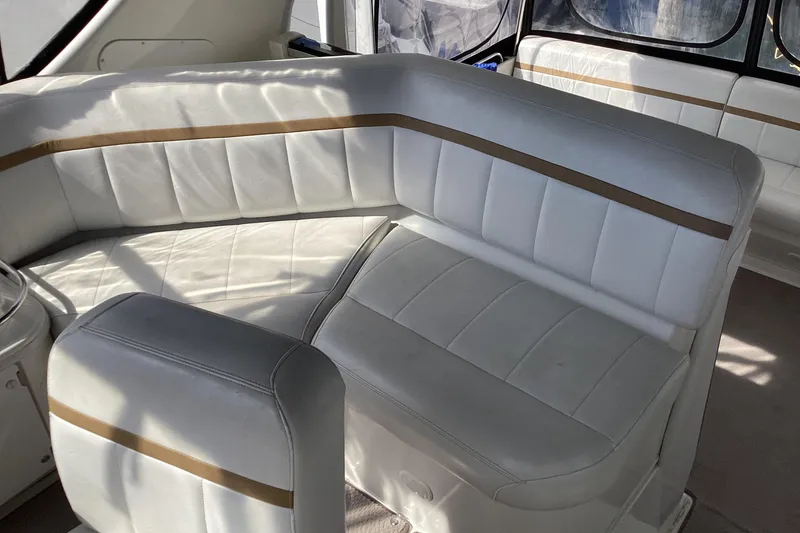 Slide: The Image of 2005 Carver 41 Cockpit Motor Yacht interior with white leather seating and brown accents. - 30