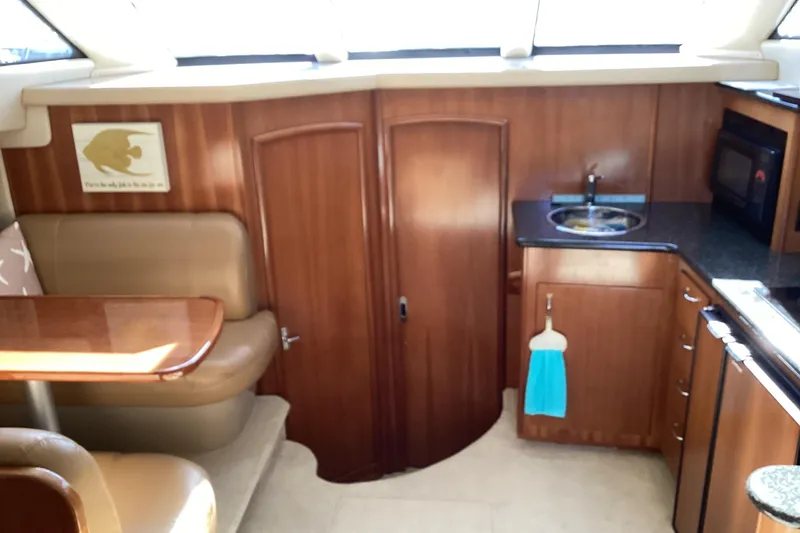 Slide: The Image of 2005 Carver 41 Cockpit Motor Yacht interior with kitchenette and dining area. - 35