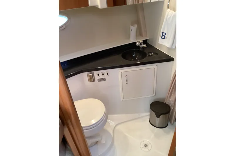 Slide: The Image of 2005 Carver 41 Cockpit Motor Yacht bathroom with sink, toilet, and storage cabinet. - 40