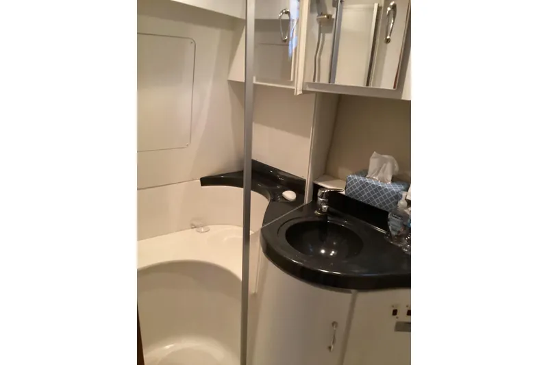 Slide: The Image of 2005 Carver 41 Cockpit Motor Yacht bathroom with modern sink and storage cabinets. - 42