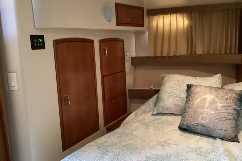 Slide: The Image of Interior of 2005 Carver 41 Cockpit Motor Yacht with cozy bedroom and wooden cabinets. - 44