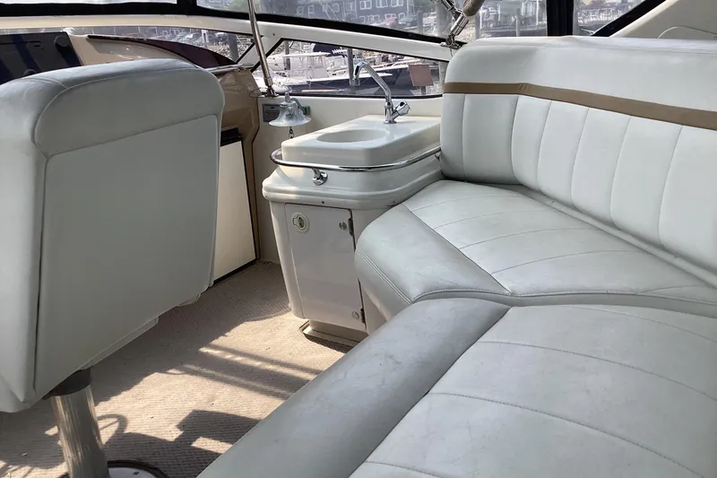 Slide: The Image of Interior of 2005 Carver 41 Cockpit Motor Yacht with white seating and compact sink. - 5