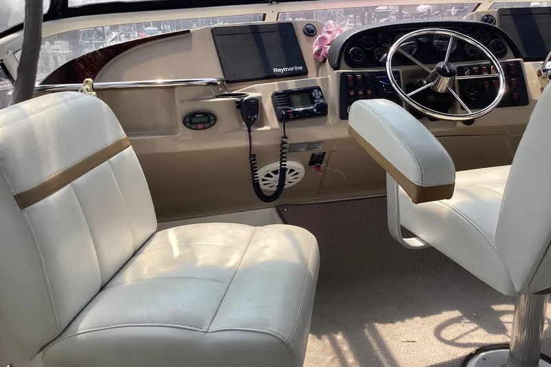 Slide: The Image of Interior cockpit of 2005 Carver 41 Cockpit Motor Yacht with steering wheel and seating. - 6