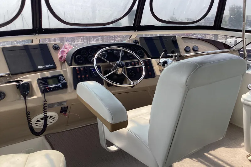 Slide: The Image of Cockpit of 2005 Carver 41 Cockpit Motor Yacht with steering wheel and navigation equipment. - 7