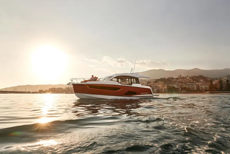 Slide: The Image of 2026 Sealine C430 yacht cruising at sunset near coastal city. - 11