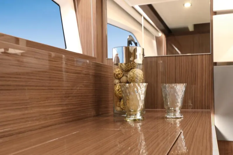 Slide: The Image of 2026 Sealine C430 yacht interior with wooden finish and decorative glassware. - 25