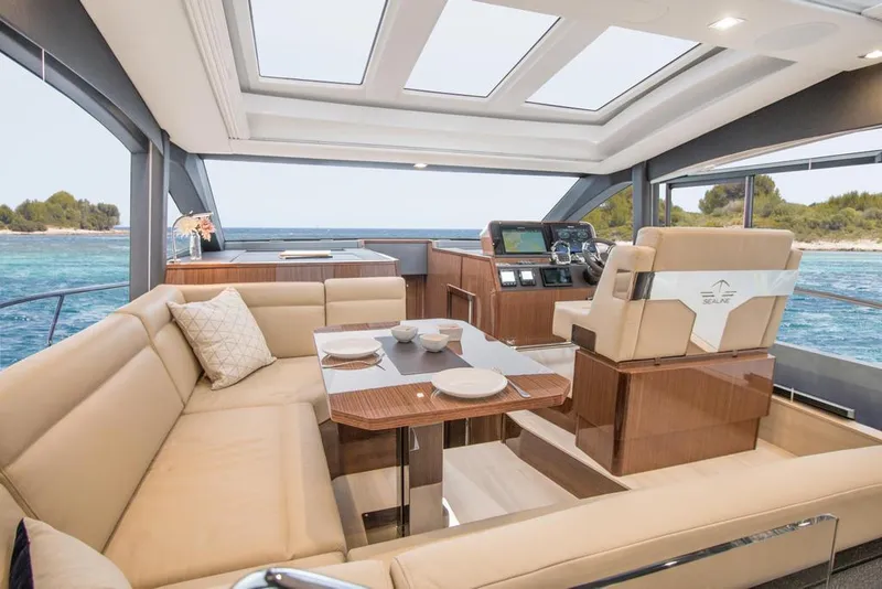 Slide: The Image of Luxurious interior of 2026 Sealine C430 yacht with panoramic windows and elegant seating. - 38