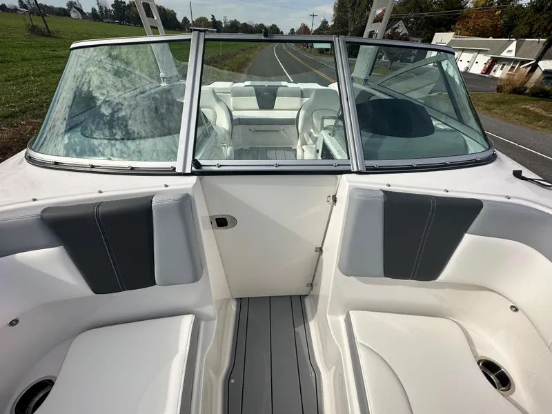 Slide: The Image of 2024 Chaparral 23 SSi boat interior with white and gray seating. - 11