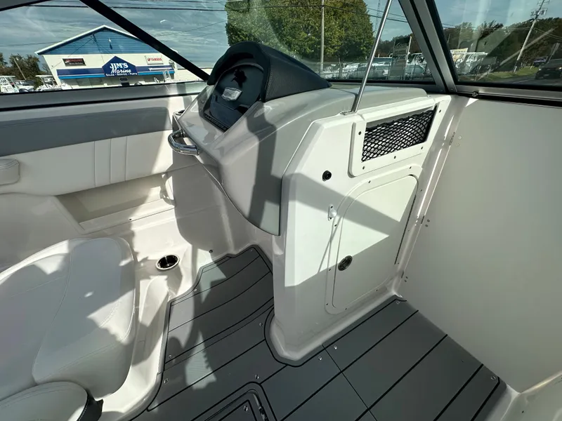 Slide: The Image of 2024 Chaparral 23 SSi boat interior, featuring helm station and seating. - 13