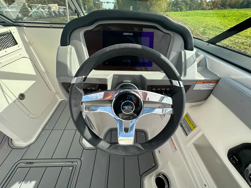 Slide: The Image of 2024 Chaparral 23 SSi boat steering wheel and dashboard. - 17