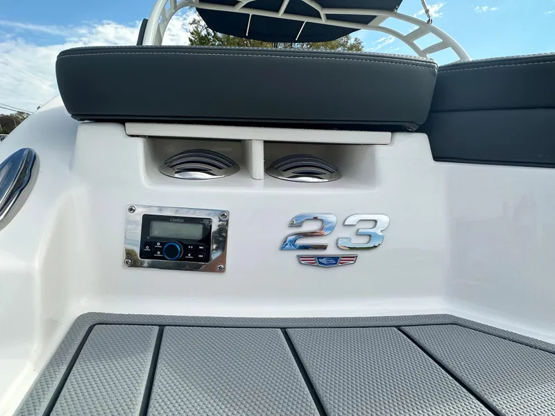 Slide: The Image of 2024 Chaparral 23 SSi boat interior with audio system and model emblem. - 2