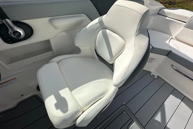 Slide: The Image of 2024 Chaparral 23 SSi boat interior with white captain's chair and modern design. - 20