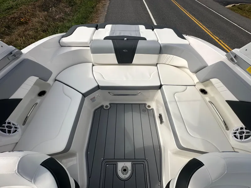 Slide: The Image of 2024 Chaparral 23 SSi boat interior with white and gray seating. - 25