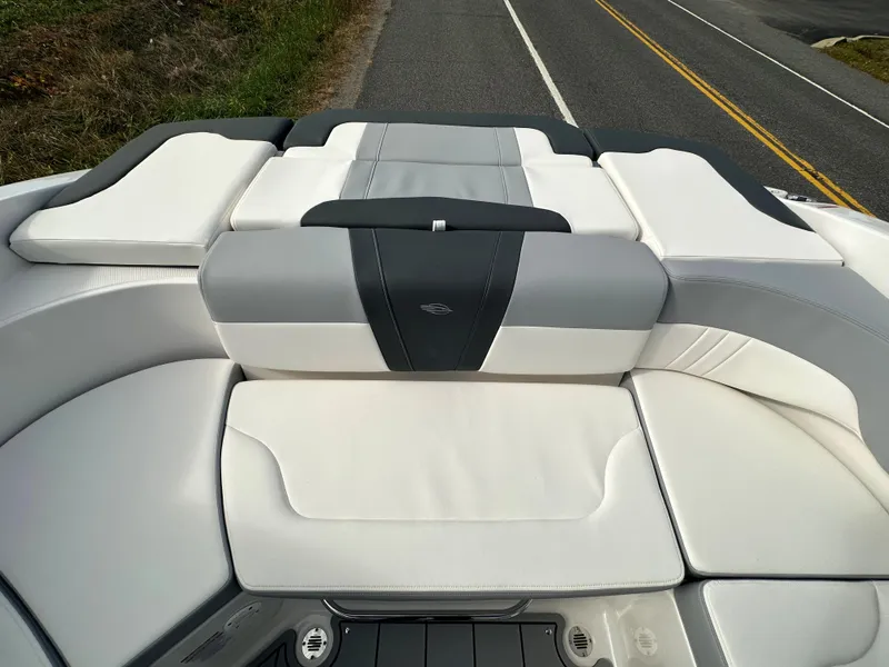 Slide: The Image of 2024 Chaparral 23 SSi boat with white and gray cushioned seating. - 27