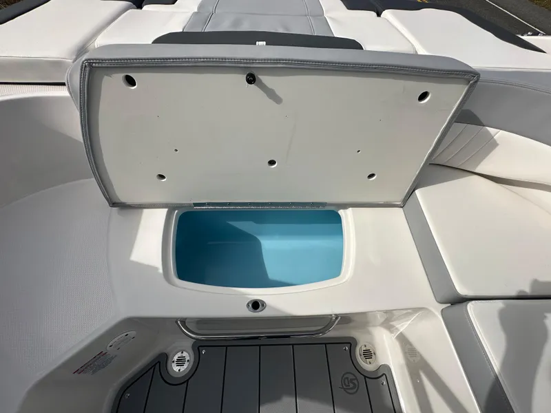 Slide: The Image of 2024 Chaparral 23 SSi boat storage compartment with open lid. - 31