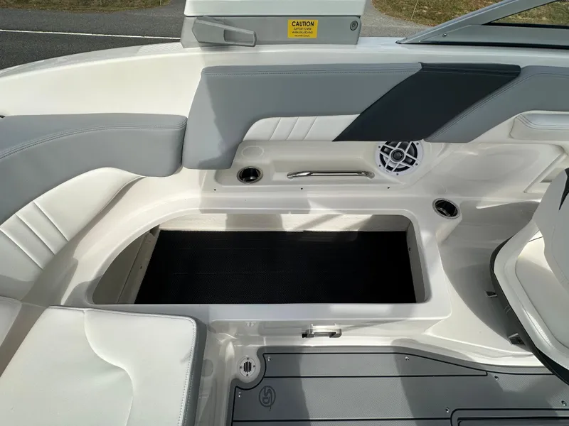 Slide: The Image of 2024 Chaparral 23 SSi boat interior with storage compartment and seating. - 32