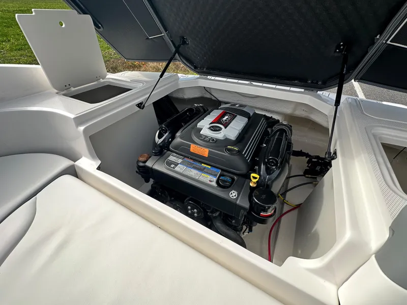 Slide: The Image of 2024 Chaparral 23 SSi boat engine compartment with open hatch. - 37