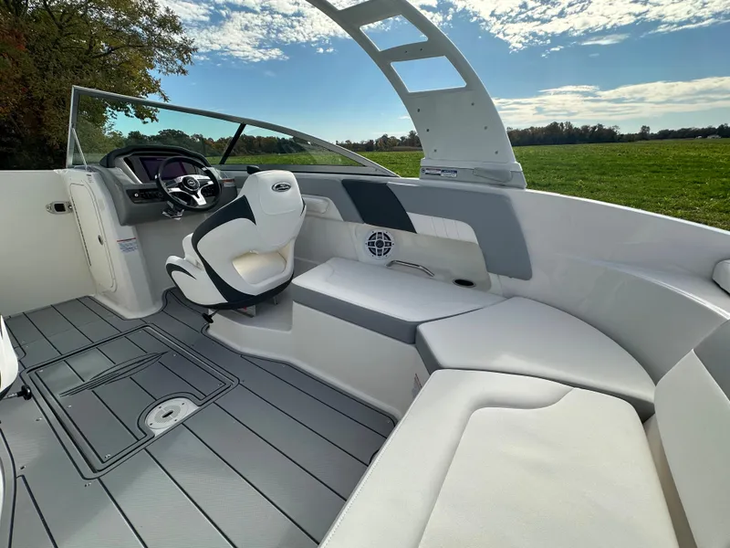 Slide: The Image of 2024 Chaparral 23 SSi boat interior with modern seating and steering wheel. - 38