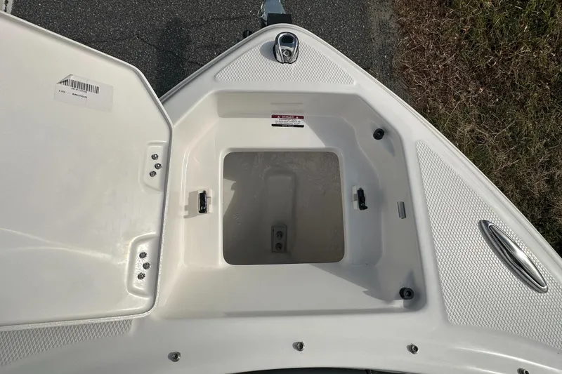 Slide: The Image of 2024 Chaparral 23 SSi boat storage compartment with open hatch. - 4