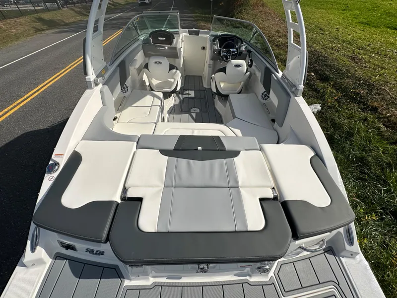 Slide: The Image of 2024 Chaparral 23 SSi boat interior with white and gray seating. - 44