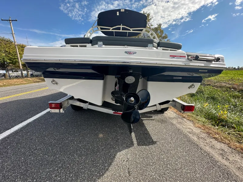 Slide: The Image of Rear view of a 2024 Chaparral 23 SSi boat on a trailer. - 48