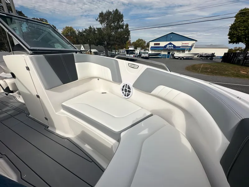 Slide: The Image of 2024 Chaparral 23 SSi boat interior with white and gray seating. - 8