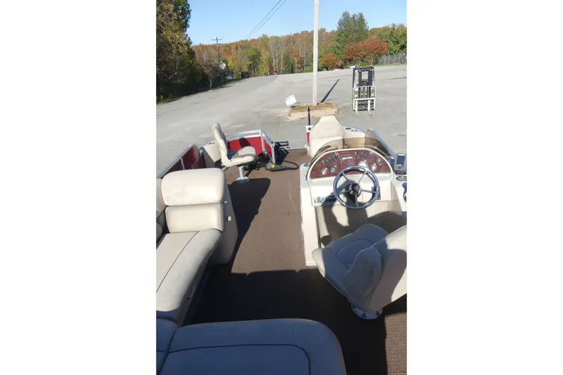 Slide: The Image of 2015 Silver Wave 230 Island F boat interior with beige seating and steering wheel. - 4