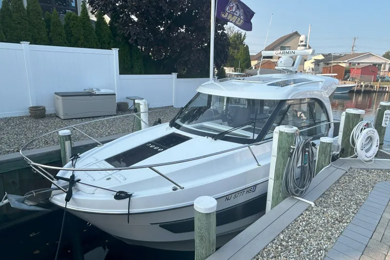 Slide: The Image of 2024 Beneteau Antares 9 docked, featuring sleek design and modern amenities. - 1