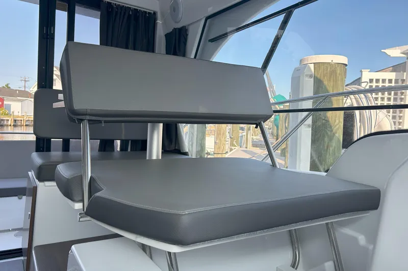 Slide: The Image of 2024 Beneteau Antares 9 interior seating with modern design and comfortable cushions. - 12