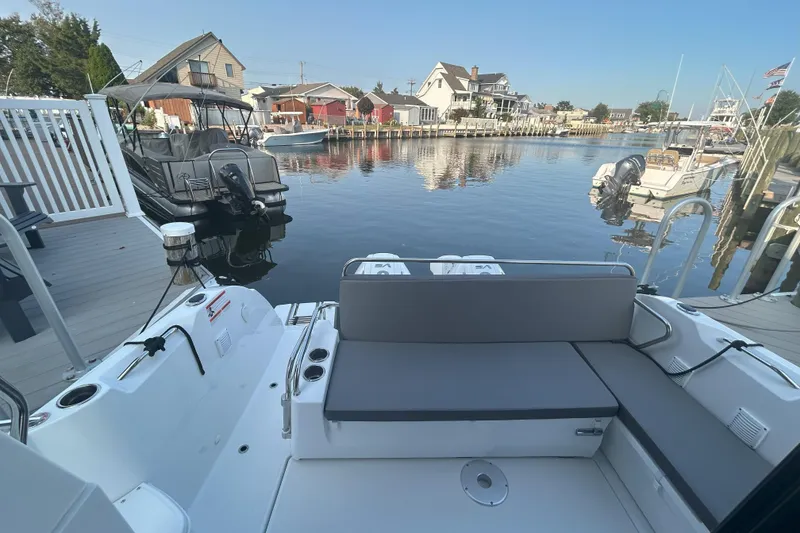 Slide: The Image of 2024 Beneteau Antares 9 docked in a serene marina setting. - 14