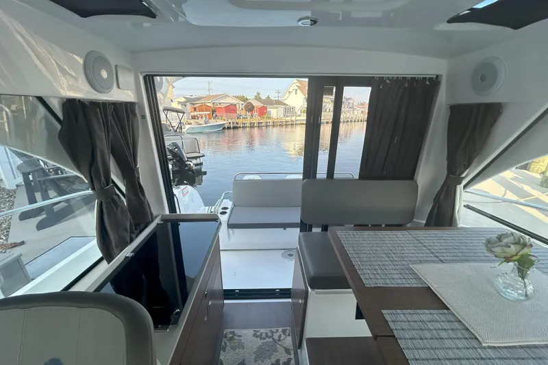 Slide: The Image of Interior of 2024 Beneteau Antares 9, featuring modern design and waterfront view. - 21