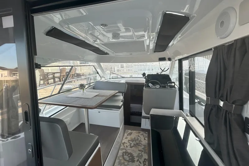 Slide: The Image of Interior of 2024 Beneteau Antares 9, featuring modern seating and dining area. - 23