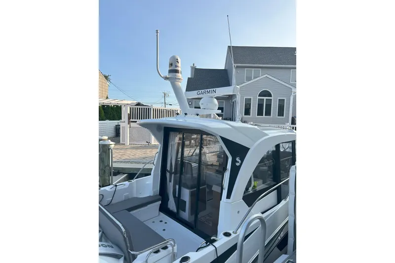 Slide: The Image of 2024 Beneteau Antares 9 boat docked, featuring Garmin equipment and modern design. - 3