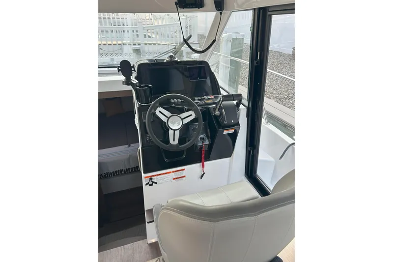 Slide: The Image of 2024 Beneteau Antares 9 helm station with steering wheel and controls. - 6