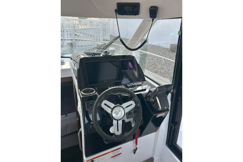 Slide: The Image of 2024 Beneteau Antares 9 helm with modern steering and navigation controls. - 7
