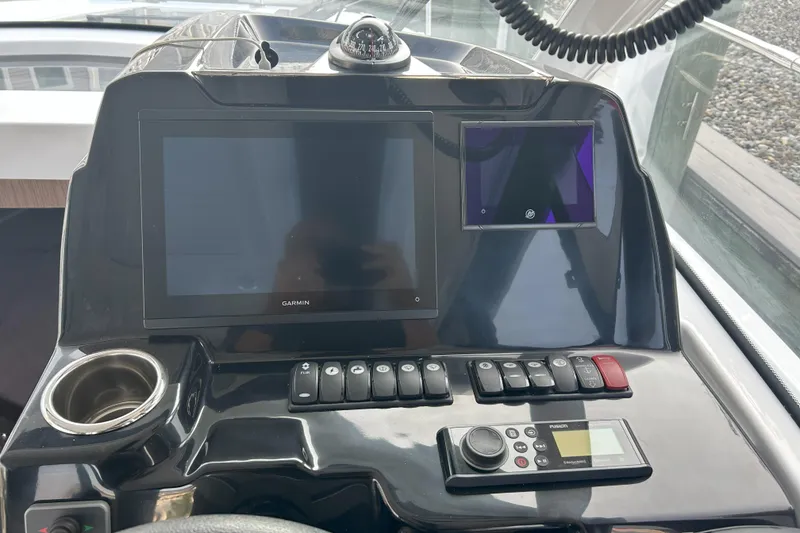 Slide: The Image of Control panel of 2024 Beneteau Antares 9 with Garmin display and navigation controls. - 8