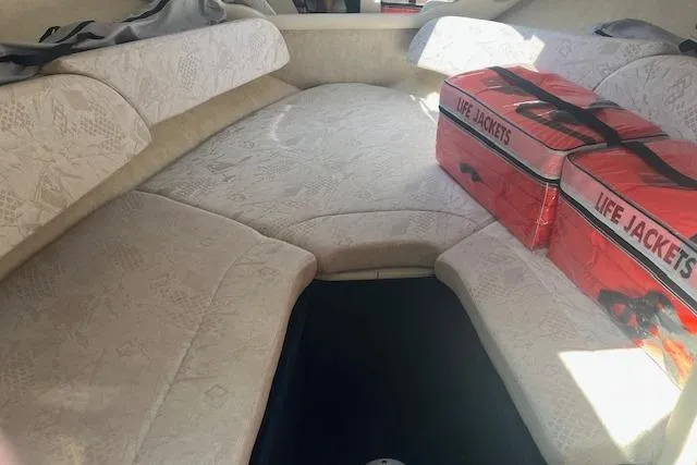 Slide: The Image of Interior of a 2001 Sea Ray 225 Weekender boat with life jackets on cushioned seating. - 10
