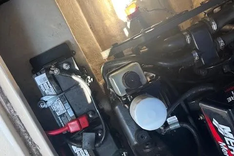 Slide: The Image of Engine compartment of a 2001 Sea Ray 225 Weekender boat, showing battery and components. - 17