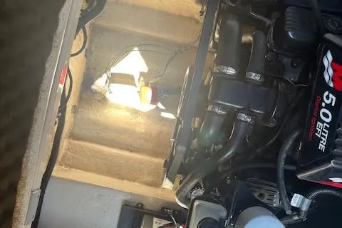 Slide: The Image of Engine compartment of a 2001 Sea Ray 225 Weekender boat, featuring a 5.0-liter engine. - 18