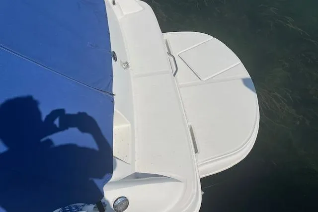 Slide: The Image of 2001 Sea Ray 225 Weekender boat with blue cover and swim platform. - 2