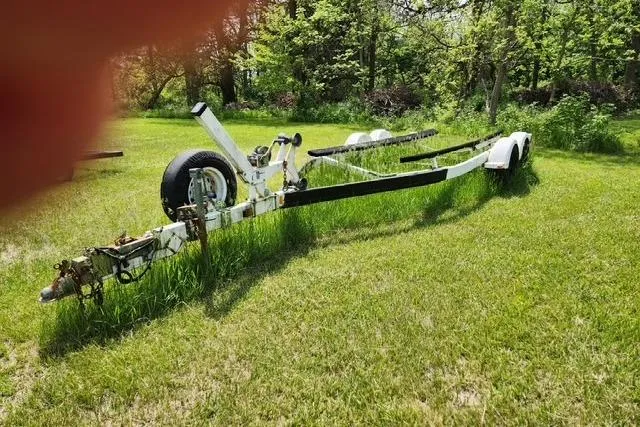 Slide: The Image of Boat trailer for 2001 Sea Ray 225 Weekender on grassy field. - 20