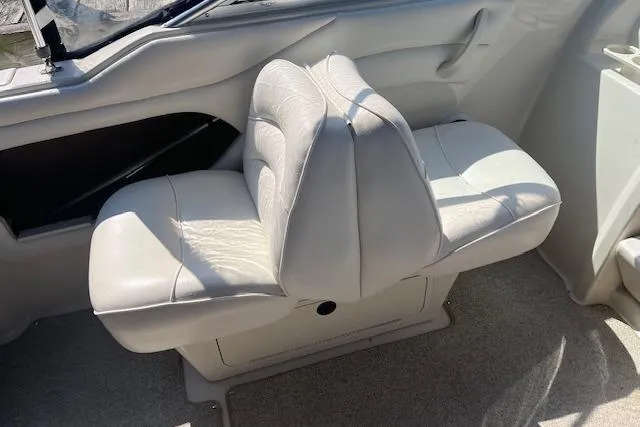 Slide: The Image of 2001 Sea Ray 225 Weekender boat interior with white leather seating. - 8