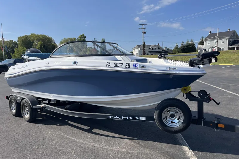 Slide: The Image of 2022 Tahoe 200 S boat on trailer in parking lot, sunny day. - 1