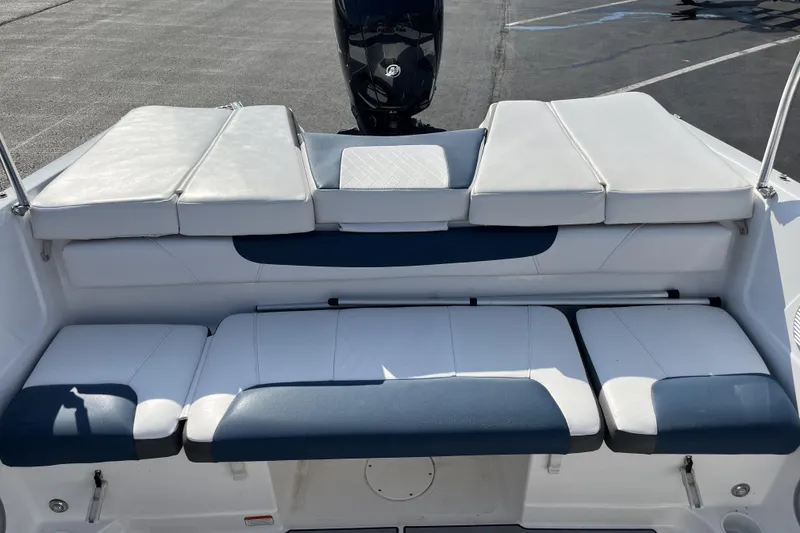Slide: The Image of 2022 Tahoe 200 S boat with white and blue cushioned seating, rear view. - 10