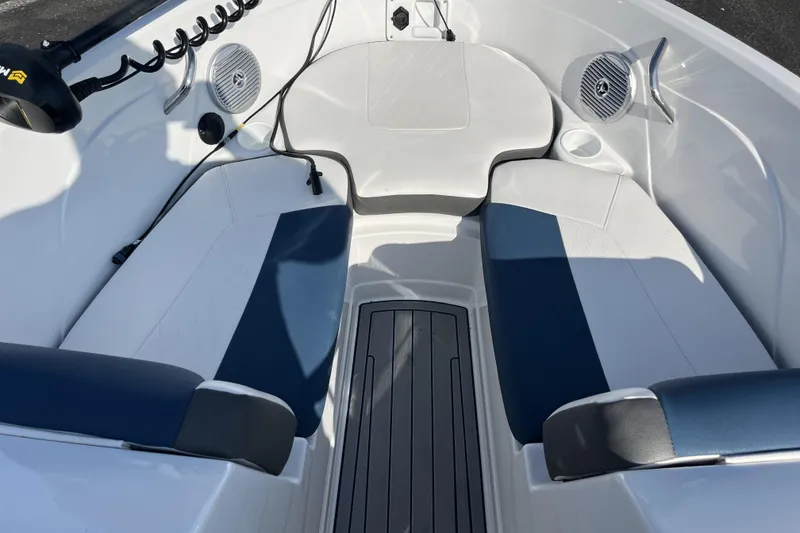 Slide: The Image of 2022 Tahoe 200 S boat interior with blue and white seating, speakers, and storage. - 11